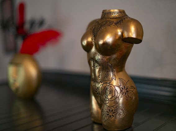 Engraved gold torso sculpture