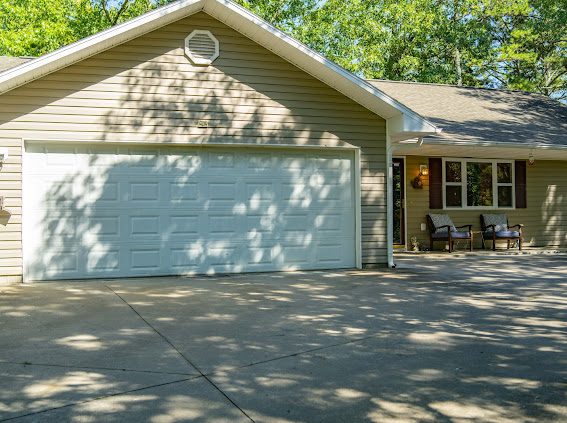 Exterior and private driveway surrounded by trees