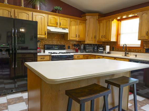 Full kitchen with island and bar stools