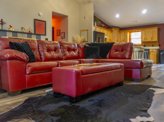 Red leather sectional and ottoman in the living room